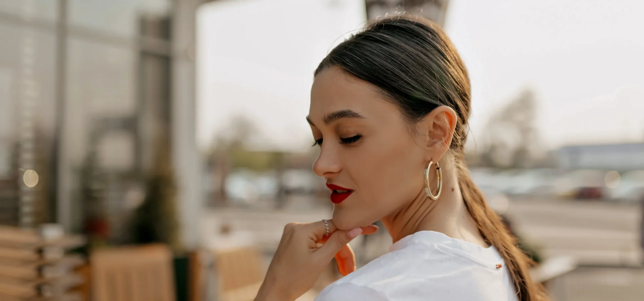 Portrait brunette woman wearing golden earnings